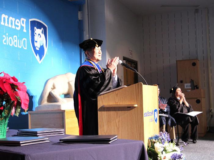 Jungwoo Ryoo, chancellor and chief academic officer, leads a round of applause for parents and family members who supported the graduates during the fall 2024 commencement celebration at Penn State DuBois.